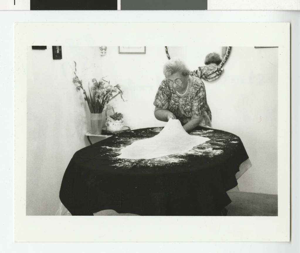 Woman stretching strudel dough